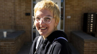 Emily Wendland stands in front of their apartment building on Lincoln Street. Oct. 13, 2021.