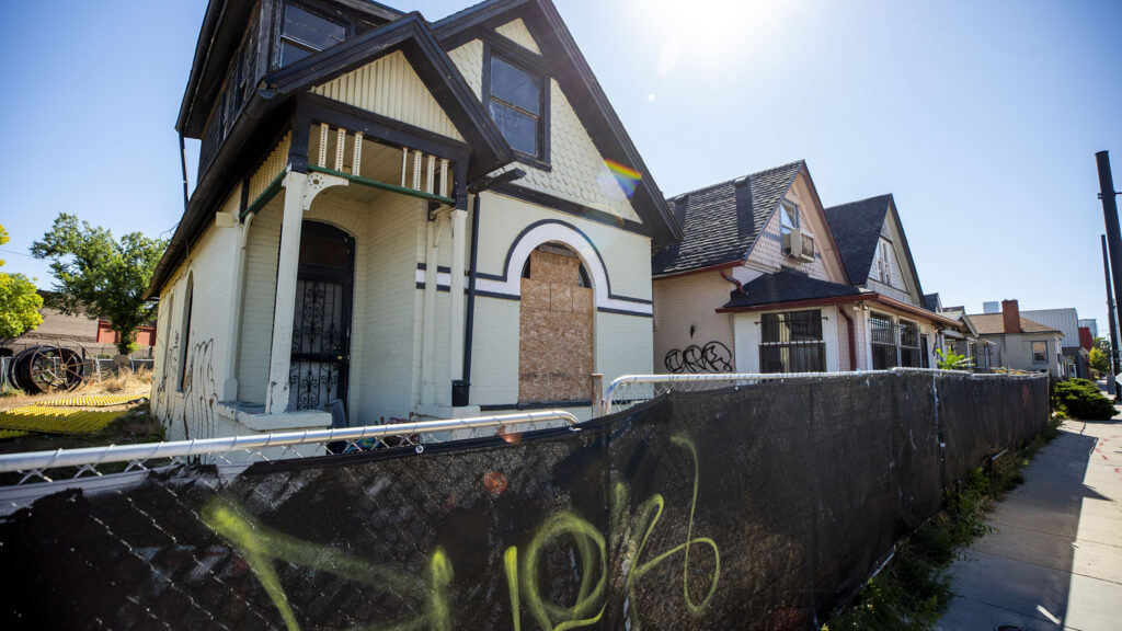 Fenced-off homes on the 3000 block of Welton Street. Oct. 13, 2021.