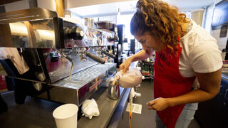 Diana De La Rosa Santiago runs the counter at Strong, Smart & Bold Beans, the Girls Inc. coffee shop at Steam on the Platte in Sun Valley. Oct. 15, 2021.