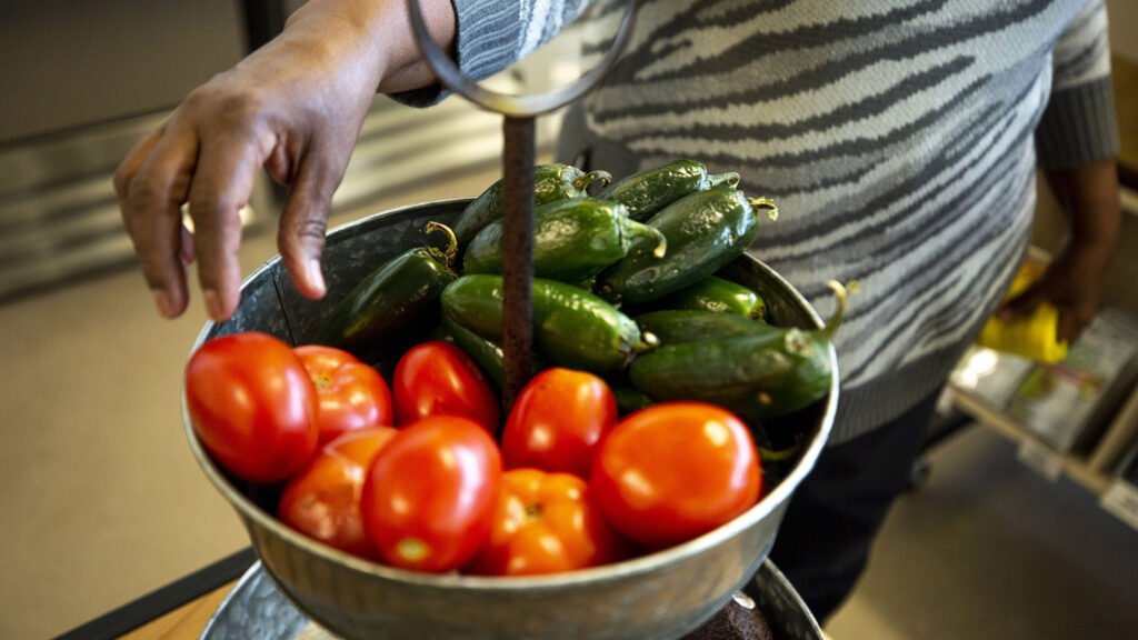 Zahara Ahmed tidies up at Sun Valley's Decatur Fresh market. Nov. 4, 2021.