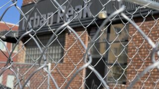 A metal fence outside Urban Peak, at 2100 Stout Street.