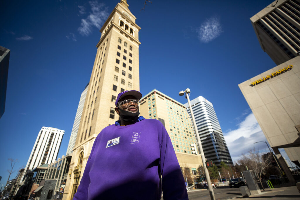 James Kinney finishes one lap between Curtis and Wewatta Streets downtown. He'll keep going on the circle, picking up trash and sweeping, until his eight-hour shift is over. Nov. 23, 2021.