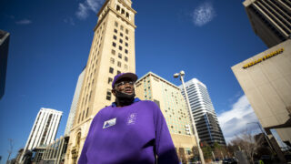 James Kinney finishes one lap between Curtis and Wewatta Streets downtown. He'll keep going on the circle, picking up trash and sweeping, until his eight-hour shift is over. Nov. 23, 2021.