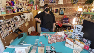 Erika Righter stands begind her register at Hope Tank on South Broadway. Dec. 13, 2021.