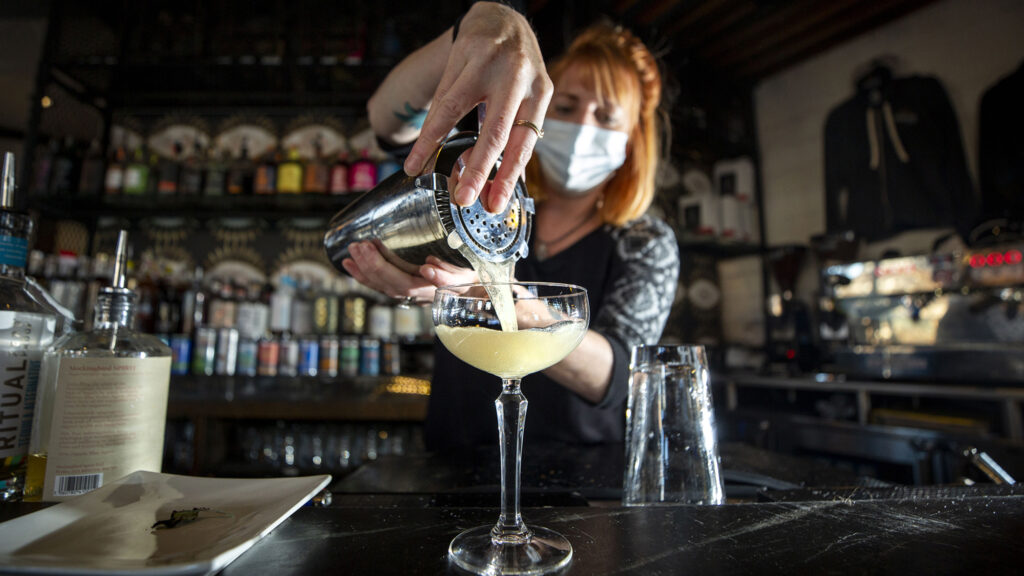 Chelsie Kipp mixes up a "honeybee sage" at Awake Sober Bar and Coffee House. Dec. 18, 2021.