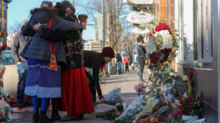 Mourners pay their respects outside Denver's Sol Tribe Custom Tattoo and Body Piercing, on Broadway at 1st, on Tuesday, Dec. 28, 2021.