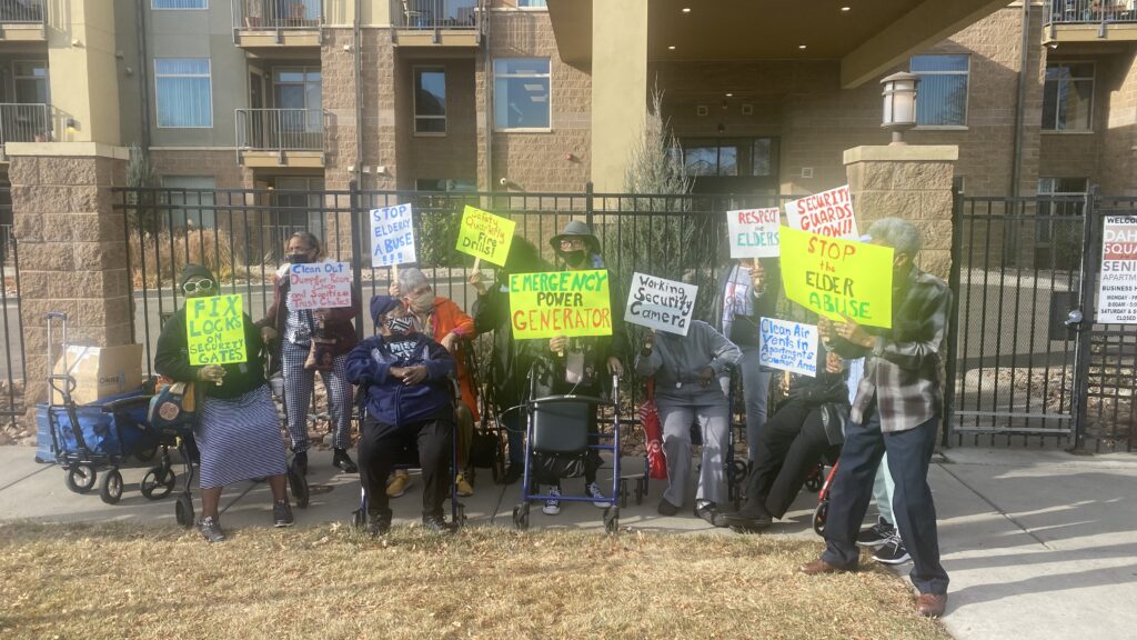 Residents of the Dahlia Square Senior Apartments in Northeast Park Hill stand outside during a press conference.