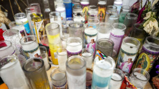 Prayer candles left for the victims of white supremacist murders line the sidewalk outside of Sol Tribe Tattoo on South Broadway in Denver. Jan. 8, 2022.