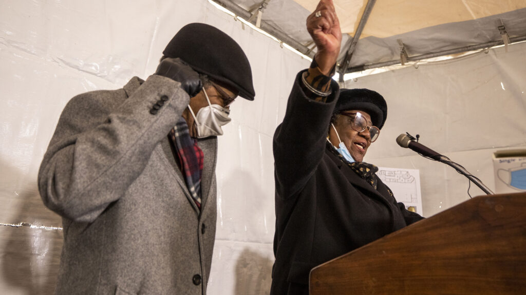 Eddie Woolfolk cheers the groundbreaking of the Charity's House affordable housing building on Welton Street, during a press conference, with her husband, Robert. Jan. 21, 2022.