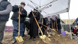 Robert and Eddie Woolfolk (center) throw dirt with ceremonial shovels during a groundbreaking ceremony for Charity's House on Friday, Jan. 21, 2022.