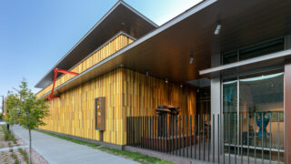 Bannock Street Façade of Kirkland Museum of Fine and Decorative Art designed by Jim Olson of Olson Kundig. Featuring Bob Mangold’s 1982 Double Tetrahedralhypersphere No. 41 (mounted at left), and a view into the indoor and outdoor sculpture galleries at Kirkland Museum. Edgar Britton’s Yin and Yang bronze sculpture, 1964, is visible at center.