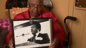 A still from 'Marvin Booker Was Murdered,' a film directed by Denver Documentary Society founder Wade Gardner.
Roxy "MaDear" Walton-Booker holds a framed image of Marvin Booker.