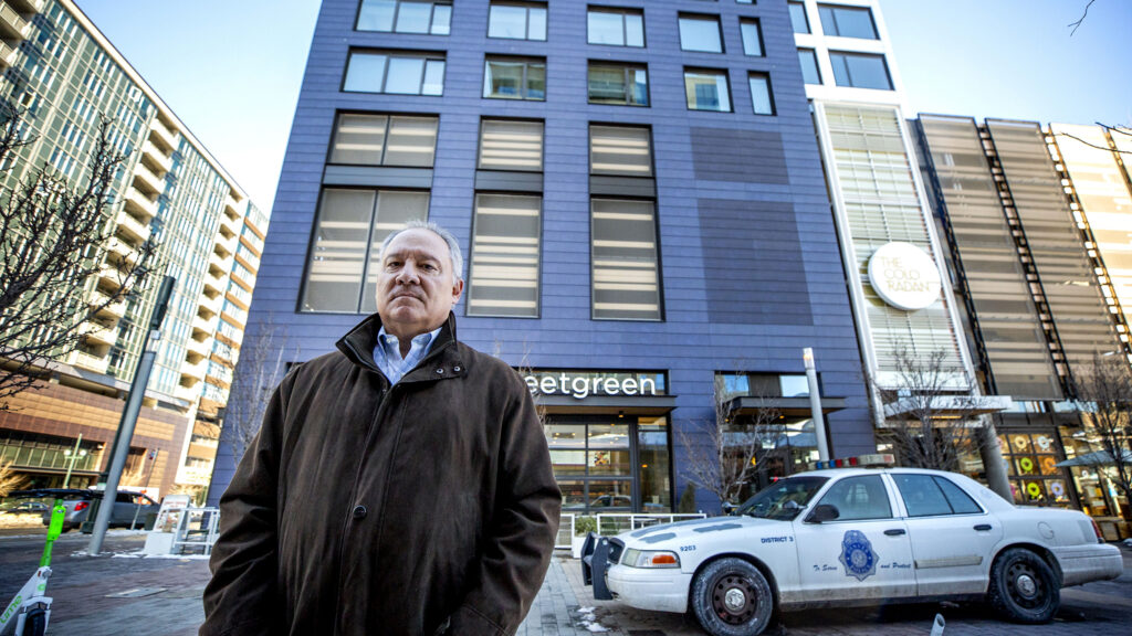 David Mazzocchi stands outside of The Coloradan condo building just across the train tracks from Union Station. Jan. 28, 2022.