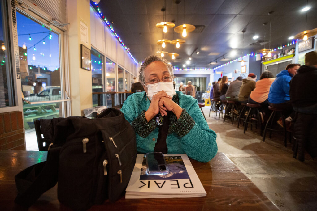 Khadija Haynes sits at a table in the Spangalang Brewery before a fundraising event for the Welton Street Cafe. Feb. 4, 2022.