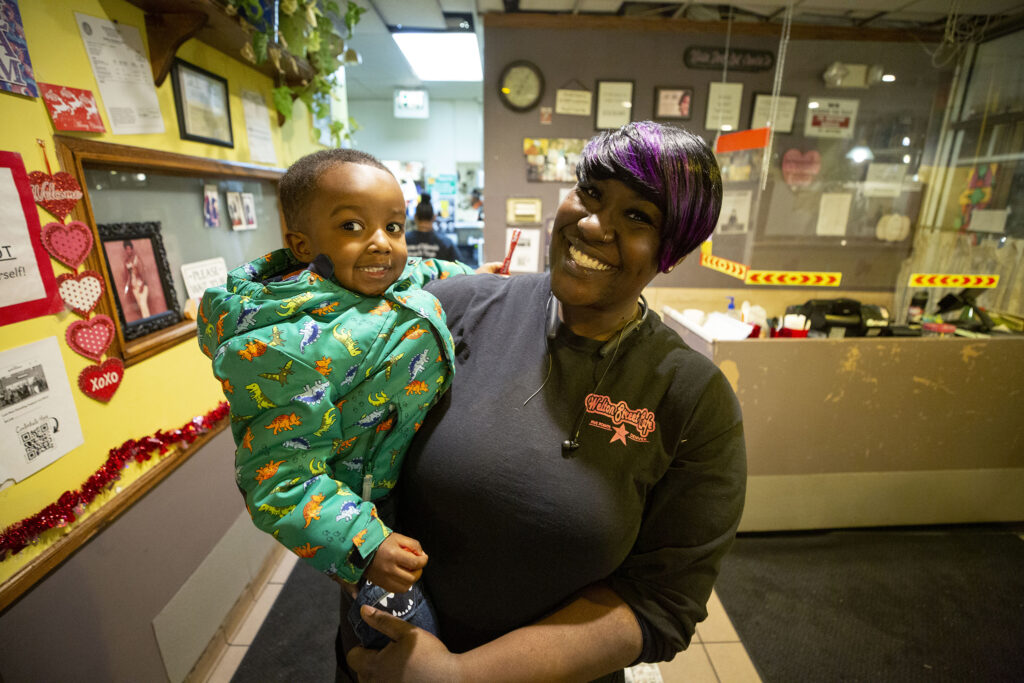 Welton Street Cafe owner Fathima Dickerson and KJ, her "spirit child," stand in the Five Points restaurant as a fundraiser for them kicks off next door. Feb. 4, 2022.