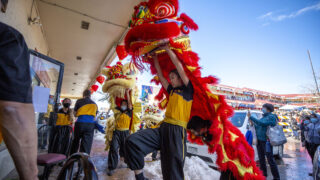 Lion dancers with Shaolin Hung Mei Kung Fu march into China Jade Restaurant during Lunar New Year festivities at Federal Boulevard's Far East Center. Feb. 5, 2022.
