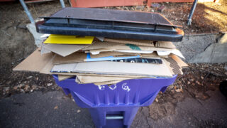 A full recycling bin in Denver's Country Club neighborhood. Feb. 15, 2022.