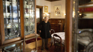 Karen Christiensen stands in the dining room of her big, old home in Capitol Hill. Feb. 18, 2022.