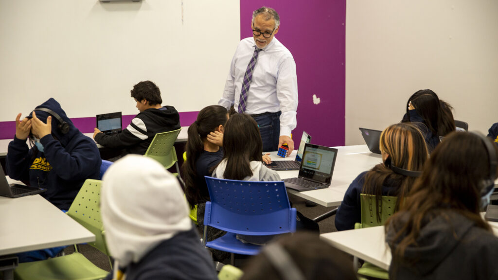 Alex Magaña, executive director of Beacon Network Schools, greets students in Ms. Bienz's class at Kepner Beacon Middle School in Westwood. March 24, 2022.