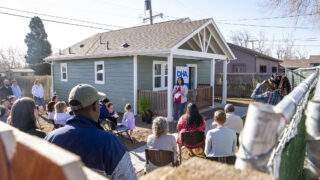 Renee Martinez-Stone, with the West Denver Renaissance Collaborative, speaks during a ribbion-cutting ceremony for a new ADU in Westwood. April 22, 2022.