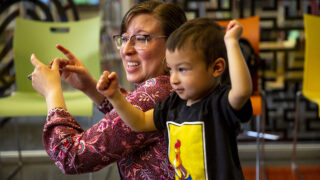 Liliana Flores Amaro sings with her son, Valentin, during bilingual story time at Elyria Swansea's Valdez-Perry Branch library. April 28, 2022.