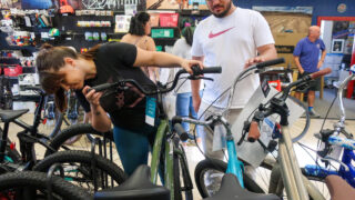 Viktor Dokulevski, right, and Lilia Asenova of Denver shop for an electric bicycle at Campus Cycles in south Denver on Saturday, May 14, 2022.