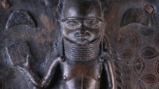 A bronze plaque stolen from the Kingdom of Benin detailing a “court nobleman or possibly a chief showing details of his regalia.”