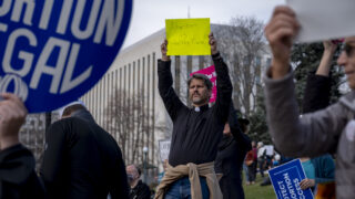 Rev. Eric Banner of the Jefferson Unitarian Church holds a sign up during a rally at the Colorado State Capitol in Denver on Tuesday, May 3, 2022, a day after a U.S. Supreme Court draft opinion overturning Roe v. Wade, which in 1973 guaranteed legal access to abortion in the country, was leaked. “I’m here for my wife. I’m here for my three daughters. I’m here for the women in the church that I serve. I’m here because of the work that my mother has been putting in for 70 plus years to make sure that abortion is recognized as healthcare, because that’s what it is. Abortion is healthcare,” said Banner, choking up.