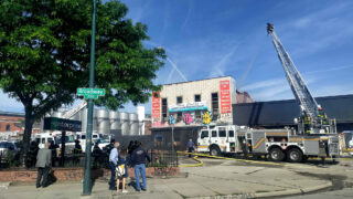 Firefighters work on a building that burned early on Friday on Arapahoe Street at Broadway. June 3, 2022.