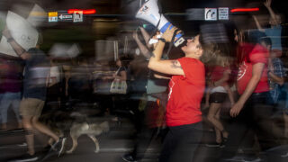 Katlyn Howery, with the Party for Socialism and Liberation, yells into a bullhorn as protesters march against the Supreme Court's overturning of Roe v. Wade. June 24, 2022.