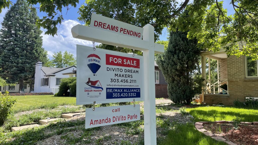 A real estate sign in Park Hill states "Dreams Pending."