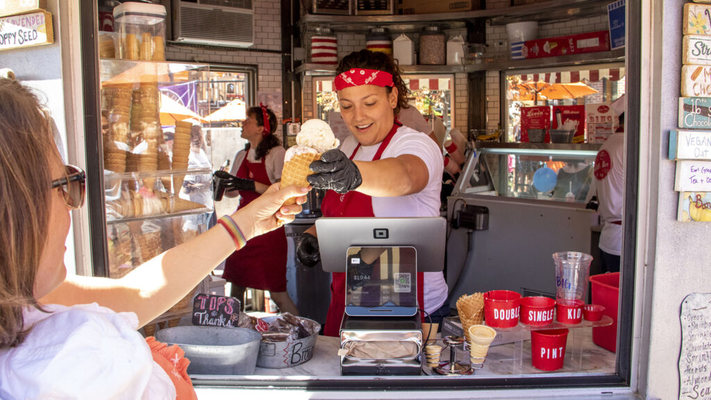 Little Man Ice Cream manager Victoria Huber takes care of customers at the company's Highland location. July 4, 2022.