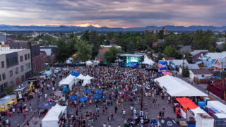 Fans crowd around the Underground Music Showcase's main stage in the South Broadway Goodwill parking lot. July 30, 2022.