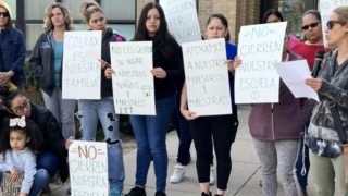 Mothers of students at Colfax Elementary School in Denver rally in April against Denver Public Schools possibly closing Colfax due to declining enrollment. Their signs have slogans including, “Don’t Close Our School,” “Colfax is Our Family,” and “DPS, Please Listen.”