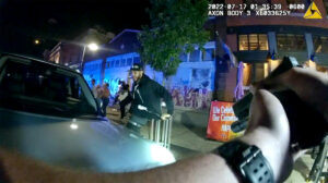 A still from Denver Police bodycam footage from July 17, 2022, when officers fired into a LoDo crowd after a fight on the sidewalk.