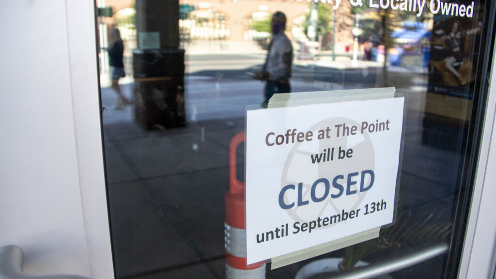 Customers mill around on Welton Street after learning Coffee At The Point will be closed until September. Aug. 2, 2022.