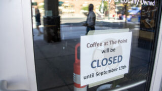 Customers mill around on Welton Street after learning Coffee At The Point will be closed until September. Aug. 2, 2022.