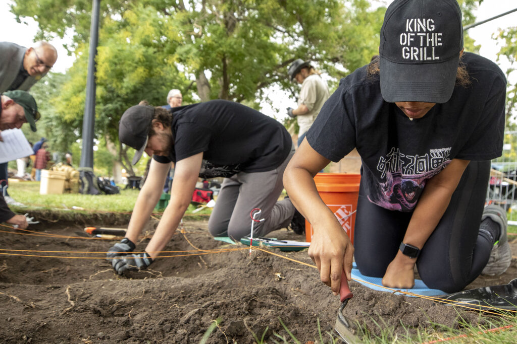 Metropolitan State University students Preston Reynolds (left) and Camryn Baucom excavate a section of Denver's Auraria Campus where a carriage house stood before the city transformed the neighborhood into an education hub. Sept. 9, 2022.