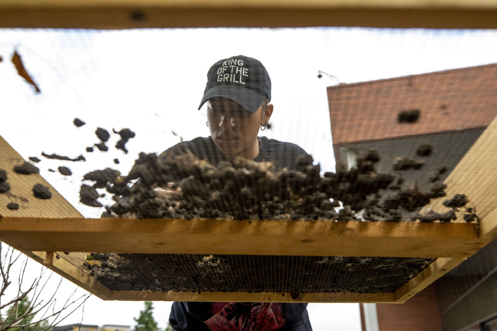Camryn Baucom, an archaeology student at Metropolitan State University, sifts through dirt she dug up on Denver's Auraria Campus, where a carriage house stood before the city transformed the neighborhood into an education hub. Sept. 9, 2022.