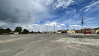 A concrete parking lot may soon be the site of a hundred-plus rowhomes.