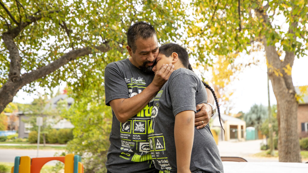 Jorge Zaldivar embraces his son, Francysco, during a party celebrating his return to Denver at the Mountain View Friends Meeting in University Park. Oct. 15, 2022.