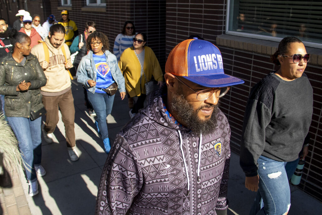 Brandon Pryor marches with his supporters in protest against his ban from Denver Public School Properties, and equity issues more generally, down Welton Street to DPS' headquarters on Lincoln Street. Oct. 26, 2022.