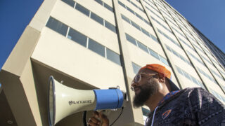 Brandon Pryor speaks to supporters during a protest against his ban from Denver Public School Properties, and equity issues more generally, in front of DPS' headquarters on Lincoln Street. Oct. 26, 2022.
