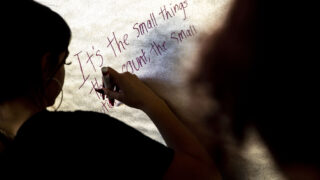 Alice Pearson writes a blessing, or an intention, onto a piece of insulation that will be installed in the Lighthouse Writers Workshop's future home on York Street. Nov. 2, 2022.