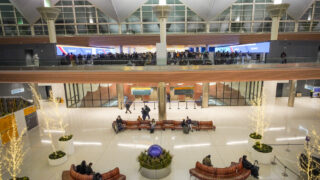 The check-in area for Southwest Airlines was crowded, above, while the meeting area for arrivals was quiet in the main terminal at Denver International Airport, Thursday morning, Dec. 12, 2022. A severe winter storm, with snow and temperatures dipping into the minus 10 range, meant many canceled or delayed flights here and across the country.