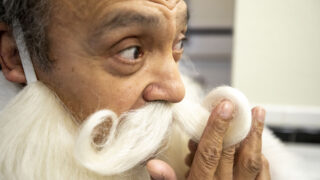 Angelo Mendez slips into his role as Santa Claus at Lakewood's Camp Christmas. Dec. 1, 2022.