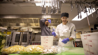 Louisa Grajeda (right) and Natayvia Tate work in the kitchen at Emily's Cafe at the Emily Griffith Technical College in North Capitol Hill. Dec. 6, 2022.
