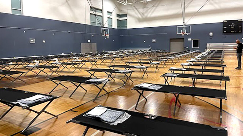 An emergency shelter for people from the U.S. border, set up at an unnamed rec center.