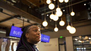 KUVO general manager Nikki Swarn stands in Rocky Mountain Public Media's new headquarters at 21st and Arapahoe Streets. Dec. 9, 2022.