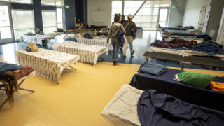 Cots set up in an emergency shelter for people arriving from the southern U.S. border, set up at a Denver rec center. Dec. 13, 2022.